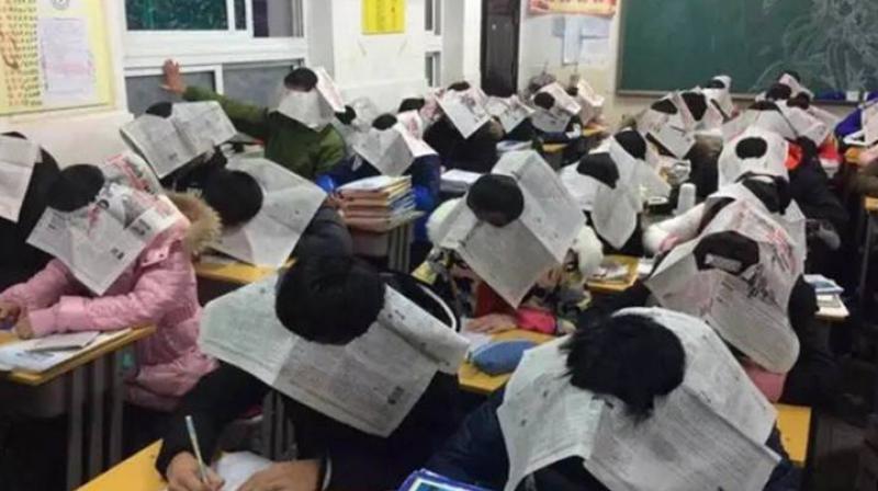The school, which is situated in the Anhui province, ensured that its pupils wore the unusual headgear in class while attempting their exams. (Credit: Twitter/ @mutazdoceo) The school, which is situated in the Anhui province, ensured that its pupils wore the unusual headgear in class while attempting their exams. (Credit: Twitter/ @mutazdoceo)