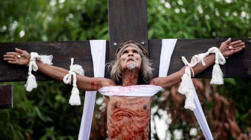 Eight centimetre (three-inch) spikes are driven through both the man's hands and feet before the wooden cross is raised briefly for the crowds to see. (Photo: AFP) Eight centimetre (three-inch) spikes are driven through both the man's hands and feet before the wooden cross is raised briefly for the crowds to see. (Photo: AFP)