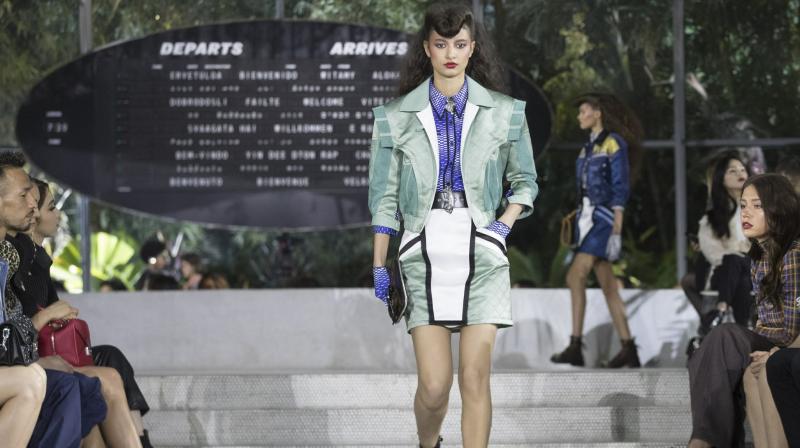 The collection had a fall feel, with plenty of leather jackets, skirts and coats, but also pieces that mixed materials, like a blue, white and black leather jacket that transformed into a flowing gold material at the chest. (Photo: AP) The collection had a fall feel, with plenty of leather jackets, skirts and coats, but also pieces that mixed materials, like a blue, white and black leather jacket that transformed into a flowing gold material at the chest. (Photo: AP)