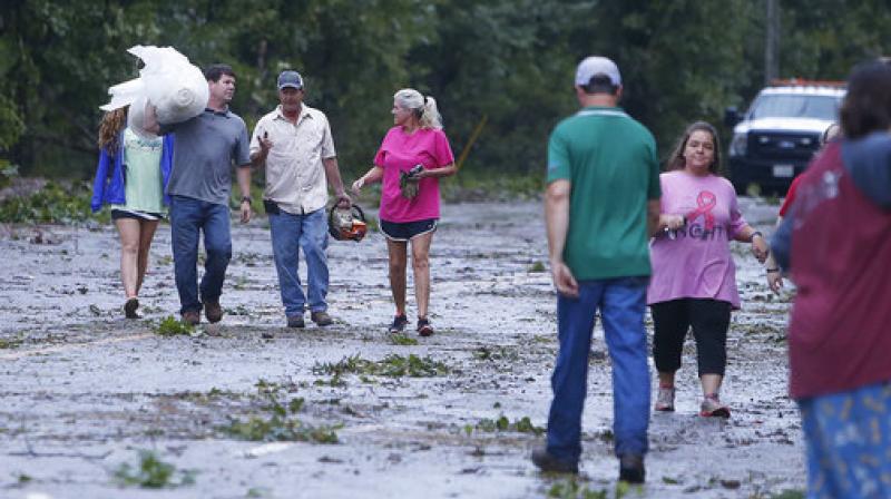 Neighbors gather supplies to help move debris from homes along Highway 18 in Fayette, Ala., after a tornado went through Fayette County. (Photo: AP) Neighbors gather supplies to help move debris from homes along Highway 18 in Fayette, Ala., after a tornado went through Fayette County. (Photo: AP)