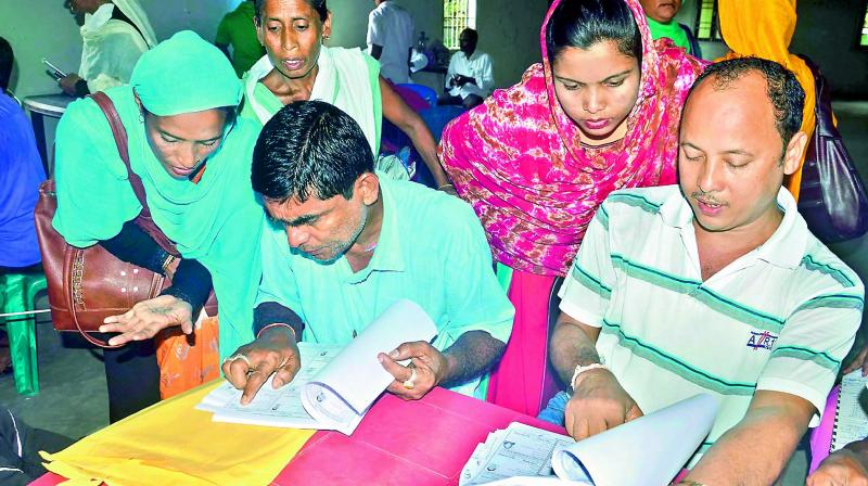 People check their names on the National Register of Citizens final list at an NRC centre in Buraburi Gaon, Morigaon in Assam. (Photo: PTI) People check their names on the National Register of Citizens final list at an NRC centre in Buraburi Gaon, Morigaon in Assam. (Photo: PTI)