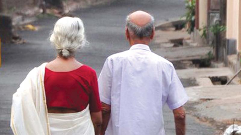 Old couple take care of each other as they walk along the road. (Photo: ANUP K. VENU) Old couple take care of each other as they walk along the road. (Photo: ANUP K. VENU)