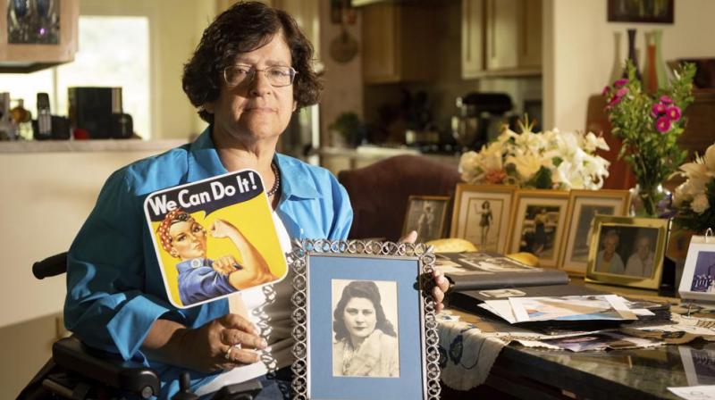 Dorene Giacopini holds up a photo of her mother Primetta Giacopini while posing for a photo at her home in Richmond, Calif. on Monday, Sept 27, 2021. (AP/Josh Edelson) Dorene Giacopini holds up a photo of her mother Primetta Giacopini while posing for a photo at her home in Richmond, Calif. on Monday, Sept 27, 2021. (AP/Josh Edelson)