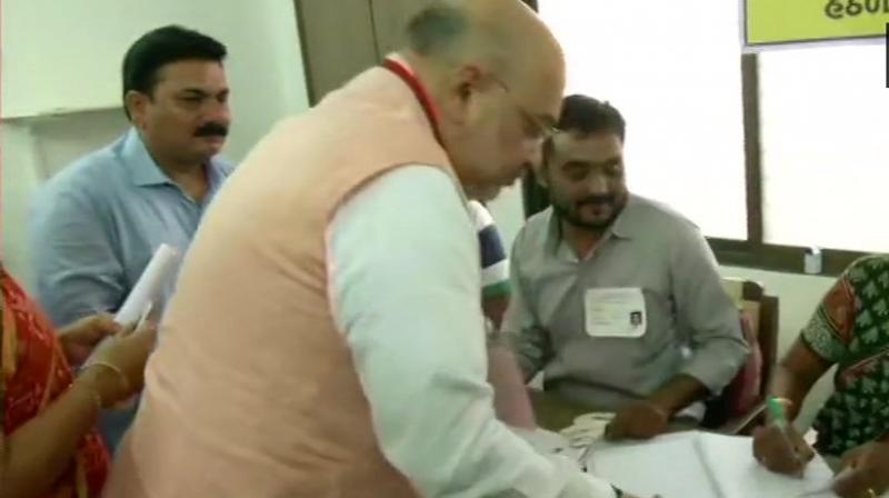 After casting his vote at the booth located in Naranpura area of Ahmedabad city, which comes under the Gandhinagar Lok Sabha constituency, he appealed to people to come out in large numbers to exercise their democratic right. (Photo: ANI | Twitter) After casting his vote at the booth located in Naranpura area of Ahmedabad city, which comes under the Gandhinagar Lok Sabha constituency, he appealed to people to come out in large numbers to exercise their democratic right. (Photo: ANI | Twitter)