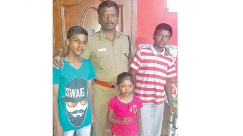 ACP Balamurugan with orphaned boy (left). Image: DC ACP Balamurugan with orphaned boy (left). Image: DC