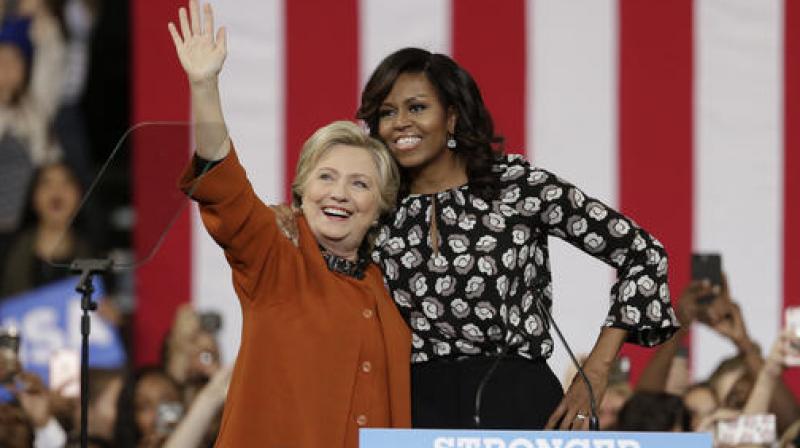 Democratic presidential candidate Hillary Clinton, accompanied by first lady Michelle Obama, greet supporters during a campaign rally in Winston-Salem, N.C. (Photo: AP) Democratic presidential candidate Hillary Clinton, accompanied by first lady Michelle Obama, greet supporters during a campaign rally in Winston-Salem, N.C. (Photo: AP)