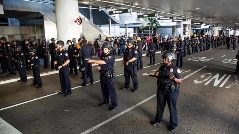 Los Angeles Airport police guard a protest against the executive order by US President Donald Trump, banning immigrants from seven majority-Muslim countries at Los Angeles International Airport in Los Angeles, California. (Photo: AFP) Los Angeles Airport police guard a protest against the executive order by US President Donald Trump, banning immigrants from seven majority-Muslim countries at Los Angeles International Airport in Los Angeles, California. (Photo: AFP)