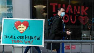 A Montefiore Medical Center employee walks past signs thanking the medical staff in New York City.AFP photo