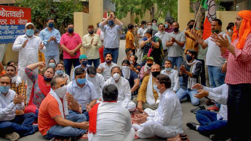 BJP workers stage a protest at the gate of the Circle Office over the arrest of a party leader, at Sector 24 of Noida. PTI Photo