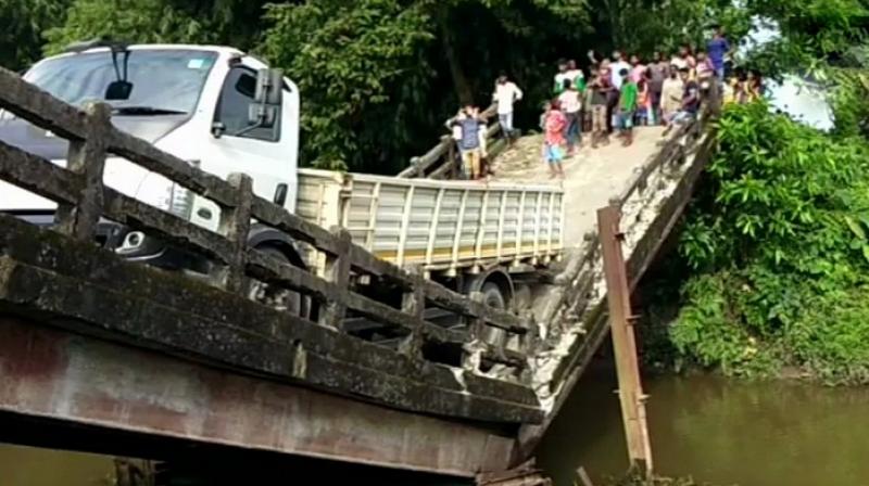 The truck is still hanging from the broken portion of the bridge that connects Manganj area to Siliguri, a major city in north Bengal. (Photo: Twitter | ANI) The truck is still hanging from the broken portion of the bridge that connects Manganj area to Siliguri, a major city in north Bengal. (Photo: Twitter | ANI)