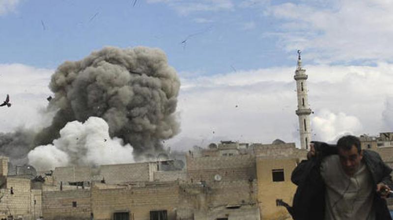 anti-government activist group Aleppo Media Center (AMC), which has been authenticated based on its contents and other AP reporting, a Syrian man, right, runs for cover from a Syrian government forces airstrike attack, in Aleppo. (Photo: AP) anti-government activist group Aleppo Media Center (AMC), which has been authenticated based on its contents and other AP reporting, a Syrian man, right, runs for cover from a Syrian government forces airstrike attack, in Aleppo. (Photo: AP)
