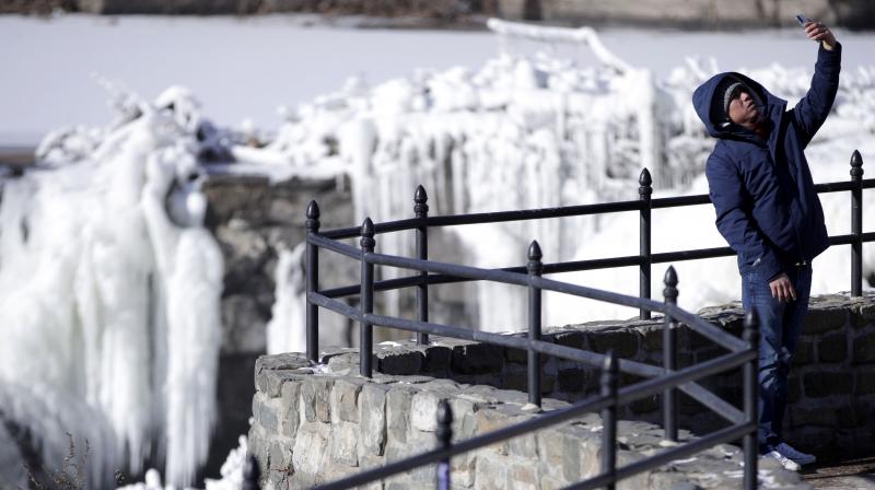 Obdulio Arenas, of Paterson, N.J., uses a cell phone to capture a selfie in front of the partially frozen falls at the Paterson Great Falls National Historical Park, Tuesday, Jan. 2, 2018, in Paterson, N.J. (Photo: AP) Obdulio Arenas, of Paterson, N.J., uses a cell phone to capture a selfie in front of the partially frozen falls at the Paterson Great Falls National Historical Park, Tuesday, Jan. 2, 2018, in Paterson, N.J. (Photo: AP)