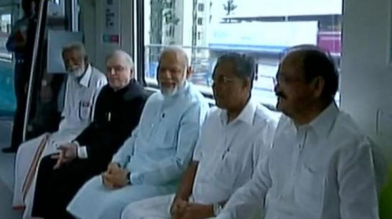 PM Narendra Modi takes a ride in Kochi Metro with CM Pinarayi Vijayan, V Naidu and E Sreedharan. (Photo: ANI/Twitter) PM Narendra Modi takes a ride in Kochi Metro with CM Pinarayi Vijayan, V Naidu and E Sreedharan. (Photo: ANI/Twitter)