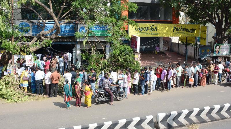 Chennai residents stand in a serpentine queue outside an ATM in Ayanavaram on Wednesday. (Photo: DC) Chennai residents stand in a serpentine queue outside an ATM in Ayanavaram on Wednesday. (Photo: DC)