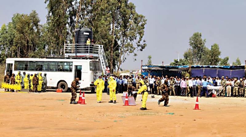 Members of National Disaster Response Force perform during a mock drill to deal with gas leak outside the Kempegowda International Airport in Bengaluru on Saturday (Photo: DC) Members of National Disaster Response Force perform during a mock drill to deal with gas leak outside the Kempegowda International Airport in Bengaluru on Saturday (Photo: DC)