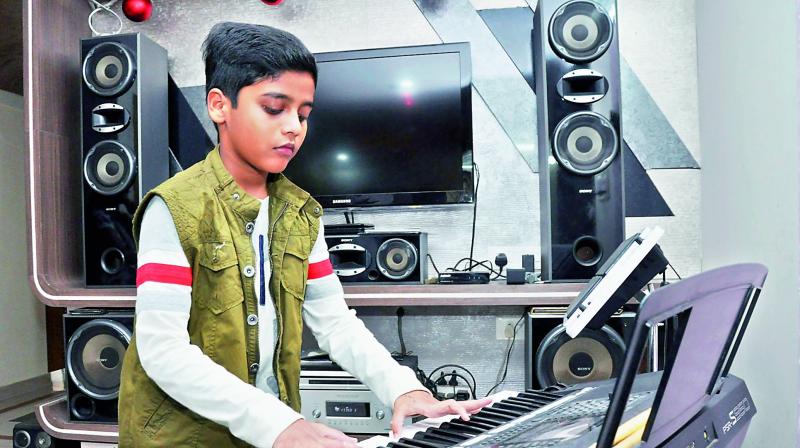 Vivek Varughese Raju plays keyboard at his residence in Visakhapatnam on Monday. (Photo: DC) Vivek Varughese Raju plays keyboard at his residence in Visakhapatnam on Monday. (Photo: DC)