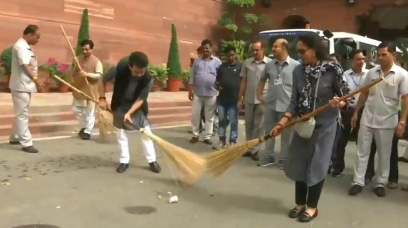 BJP leaders Hema Malini and Anurag Thakur taking part in Clean India Campaign. (Photo: Videograb/ANI) BJP leaders Hema Malini and Anurag Thakur taking part in Clean India Campaign. (Photo: Videograb/ANI)