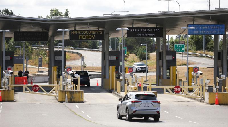 In this file photo taken on August 9, 2021 a vehicle approaches the USA-Canada border to enter the USA, which is still closed to Canadians for non-essential travel. (Jason Redmond / AFP)