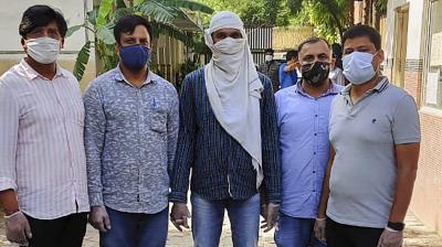 Delhi Police with an alleged ISIS operative (C) after arresting him last night following an exchange of fire and recovery of Improvised Explosive Devices (IEDs) from central Delhi's Ridge Road area, in New Delhi, Saturday. (PTI)