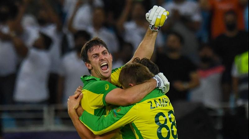 Australias Mitchell Marsh (L) celebrates their win with teammates at the end of the ICC mens Twenty20 World Cup final match between Australia and New Zealand at the Dubai International Cricket Stadium in Dubai on November 14, 2021. (Photo: AFP)