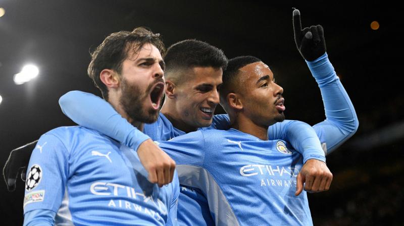 Manchester Citys Brazilian striker Gabriel Jesus (right) celebrates with Manchester Citys Portuguese midfielder Bernardo Silva (L) and Manchester Citys Portuguese defender Joao Cancelo (C) after scoring their second goal during the UEFA Champions League Group A football match between Manchester City and Paris Saint-Germain at the Etihad Stadium in Manchester, north west England, on Thursday. (Photo: AFP)