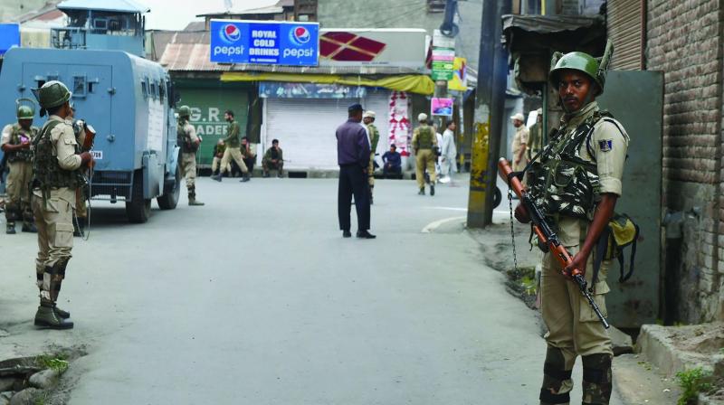 Security personnel stand guard during restrictions at Downtown in Srinagar on Saturday (Photo: AP) Security personnel stand guard during restrictions at Downtown in Srinagar on Saturday (Photo: AP)