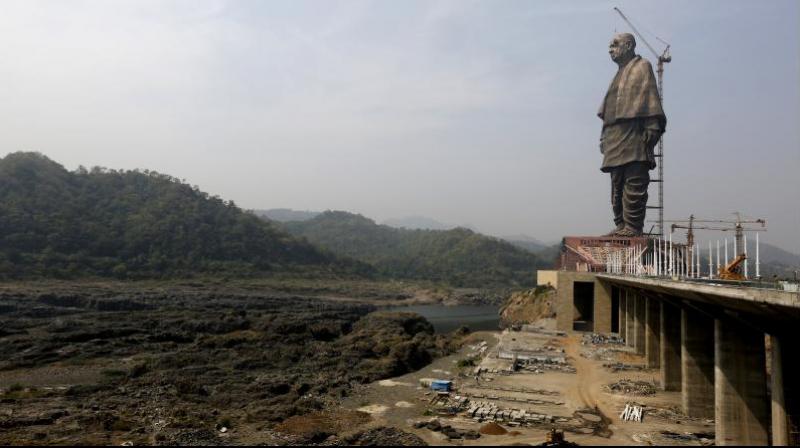 The under construction statue of unity stands facing Sardar Sarovar Dam at Kevadiya Colony, about 200 kilometers from Ahmedabad. (Photo: AP) The under construction statue of unity stands facing Sardar Sarovar Dam at Kevadiya Colony, about 200 kilometers from Ahmedabad. (Photo: AP)