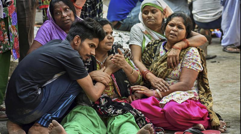 Relatives during the cremation of a victim of Friday's train accident, in Amritsar, on Sunday. (Photo: PTI) Relatives during the cremation of a victim of Friday's train accident, in Amritsar, on Sunday. (Photo: PTI)
