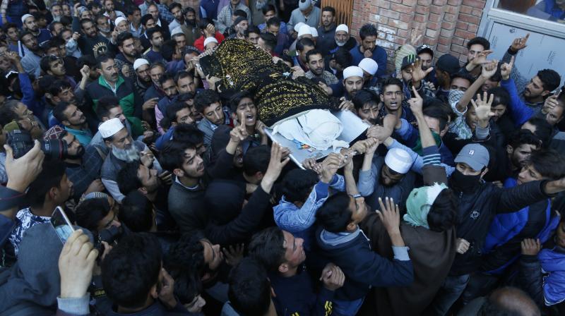 Kashmiri villagers shout pro-freedom slogans as they carry the body of Uzair Mushtaq, who was killed when unused explosives of three militants, gunned down in an encounter, went off in Kulgam. (Photo: AP) Kashmiri villagers shout pro-freedom slogans as they carry the body of Uzair Mushtaq, who was killed when unused explosives of three militants, gunned down in an encounter, went off in Kulgam. (Photo: AP)