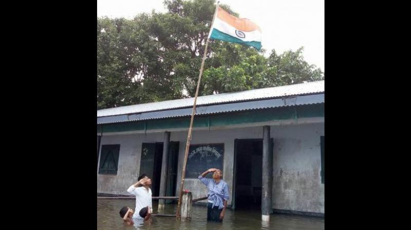 Tajen Sikdar, the head teacher of the primary school in Dhubri district, who had stood in the flood water with Haider Ali Khan and two others, said on Thursday that Haider's name was not in the draft NRC. (Photo: Facebook/@Mizanur Rahman) Tajen Sikdar, the head teacher of the primary school in Dhubri district, who had stood in the flood water with Haider Ali Khan and two others, said on Thursday that Haider's name was not in the draft NRC. (Photo: Facebook/@Mizanur Rahman)