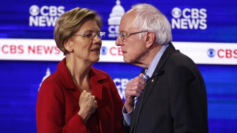 From left, Democratic presidential candidates, Sen. Elizabeth Warren, D-Mass., talks with Sen. Bernie Sanders, during a Democratic presidential primary debate at the Gaillard Center. AP photo