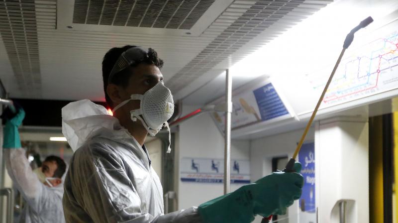 A Tehran municipality worker cleans a metro train to avoid the spread of the COVID-19 illness on. AFP photo