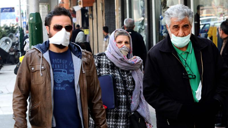 Mask-clad pedestrians walk through Tajrish Bazaar in the Iranian capital Tehran on February 29, 2020 (AFP)