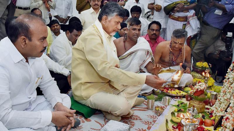 Andhra Pradesh Chief Minister N Chandrababu Naidu performs rituals after entering into his new office chamber in the Government's Transitional Headquarters at Velagapudi in the Amaravati capital region. (Photo: PTI) Andhra Pradesh Chief Minister N Chandrababu Naidu performs rituals after entering into his new office chamber in the Government's Transitional Headquarters at Velagapudi in the Amaravati capital region. (Photo: PTI)