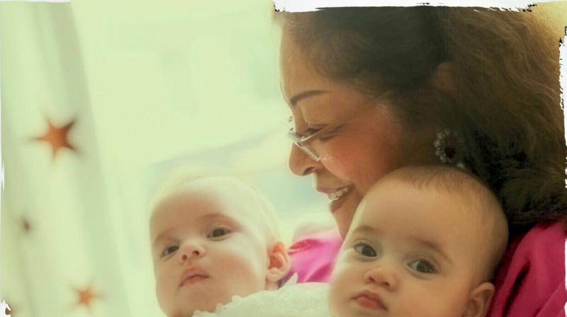 Karan's mother snapped cuddling with the twins. Karan's mother snapped cuddling with the twins.