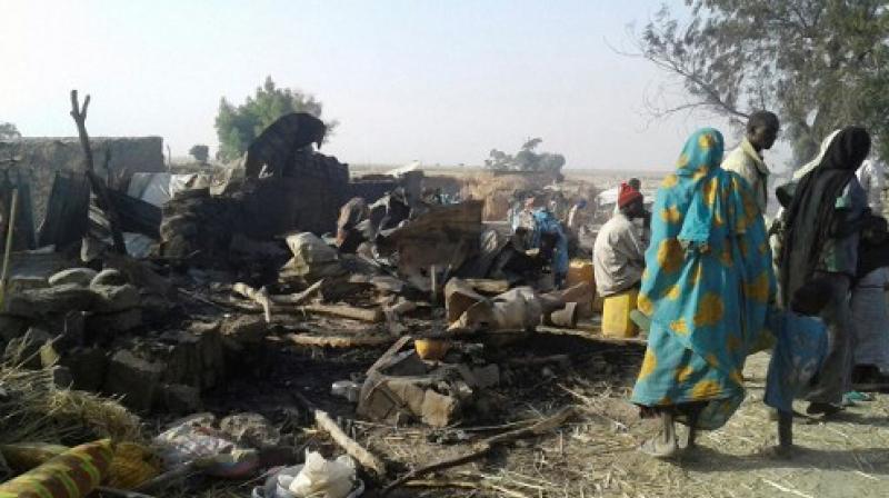 This handout image received courtesy of Doctors Without Border (MSF) shows people standing next to destruction after an air force jet accidentally bombarded a camp for those displaced by Boko Haram Islamists, in Rann, northeast Nigeria. (Photo: AFP) This handout image received courtesy of Doctors Without Border (MSF) shows people standing next to destruction after an air force jet accidentally bombarded a camp for those displaced by Boko Haram Islamists, in Rann, northeast Nigeria. (Photo: AFP)