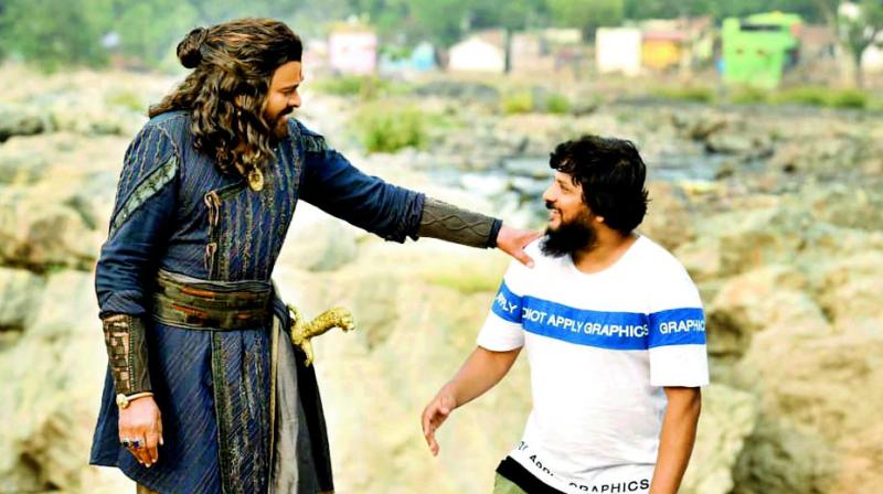 Chiranjeevi and Surender Reddy on the sets of Sye Raa Narasimha Reddy. Chiranjeevi and Surender Reddy on the sets of Sye Raa Narasimha Reddy.