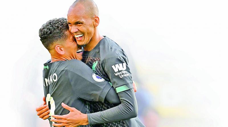 Liverpool’s Roberto Firmino (left) celebrates with Fabinho after scoring against Burnley in their EPL match in Burnley on Saturday. Liverpool won 3-0. (Photo: AFP) Liverpool’s Roberto Firmino (left) celebrates with Fabinho after scoring against Burnley in their EPL match in Burnley on Saturday. Liverpool won 3-0. (Photo: AFP)