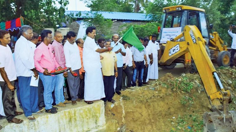 State food Minister R. Kamaraj flags off de-silting works at a canal which carries water to a local tank at Mannargudi on Saturday. (Photo: DC) State food Minister R. Kamaraj flags off de-silting works at a canal which carries water to a local tank at Mannargudi on Saturday. (Photo: DC)