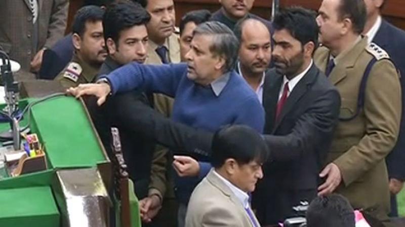 Independent MLA Pawan Gupta being marshalled out of J-K Assembly. (Photo: ANI) Independent MLA Pawan Gupta being marshalled out of J-K Assembly. (Photo: ANI)
