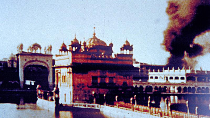 In this photograph, cloud of smoke is seen rising from an explosion behind the Manji Sahib Diwan Hall. 300 bullet holes were found in the gold panels and marble of Gurdwara Darbar Sahib after the attack. (Photo: Sikhmuseum.com) In this photograph, cloud of smoke is seen rising from an explosion behind the Manji Sahib Diwan Hall. 300 bullet holes were found in the gold panels and marble of Gurdwara Darbar Sahib after the attack. (Photo: Sikhmuseum.com)