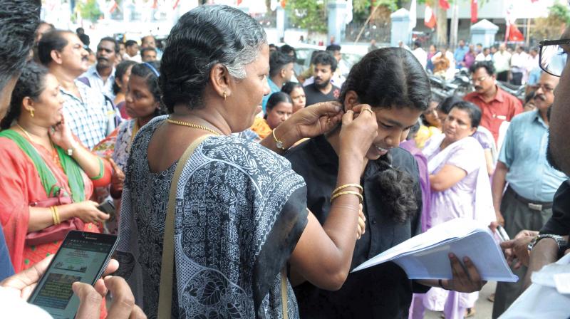 A woman removes her daughter’s earrings before the NEET examinations at Arya Central school in Thiruvananthapuram on Sunday. (Photo: DC FILE) A woman removes her daughter’s earrings before the NEET examinations at Arya Central school in Thiruvananthapuram on Sunday. (Photo: DC FILE)