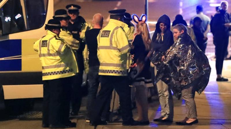 Emergency services personnel speak to people outside Manchester Arena after reports of an explosion at the venue during an Ariana Grande concert in Manchester, England. (Photo: AP) Emergency services personnel speak to people outside Manchester Arena after reports of an explosion at the venue during an Ariana Grande concert in Manchester, England. (Photo: AP)