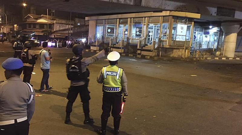 Police officers arrive on the scene after an explosion near a bus stop in the Kampung Melayu area of Jakarta, Indonesia.(Photo: AP) Police officers arrive on the scene after an explosion near a bus stop in the Kampung Melayu area of Jakarta, Indonesia.(Photo: AP)