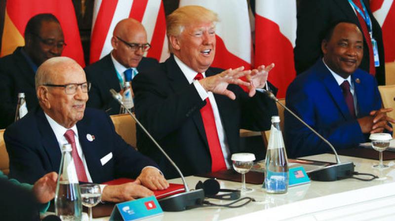 US President Donald Trump gestures while being flanked by Tunisia's President Beji Caid Essebsi, left, and Niger's President Mahamadou Issoufou, right, at a G7 Summit expanded session in Taormina, Italy. (Photo: AP) US President Donald Trump gestures while being flanked by Tunisia's President Beji Caid Essebsi, left, and Niger's President Mahamadou Issoufou, right, at a G7 Summit expanded session in Taormina, Italy. (Photo: AP)