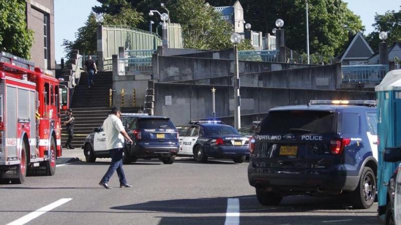 Police investigate a deadly stabbing on a Metropolitan Area Express train in northeast Portland, Oregon on Friday. (Photo: AP) Police investigate a deadly stabbing on a Metropolitan Area Express train in northeast Portland, Oregon on Friday. (Photo: AP)