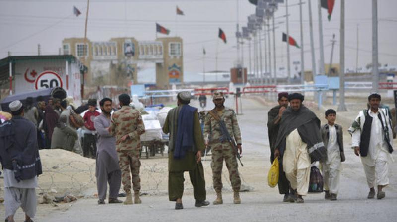 Pakistani paramilitary soldiers stand guard while people wait for the opening of the border crossing in Chaman, Pakistan. (Photo: AP) Pakistani paramilitary soldiers stand guard while people wait for the opening of the border crossing in Chaman, Pakistan. (Photo: AP)