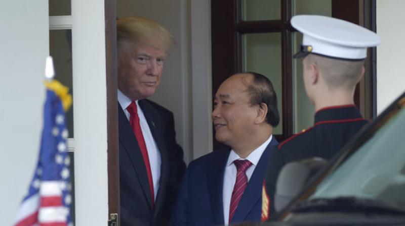President Donald Trump walks Vietnamese Prime Minister Nguyen Xuan Phuc to his car following their meeting at the White House in Washington. (Photo: AP) President Donald Trump walks Vietnamese Prime Minister Nguyen Xuan Phuc to his car following their meeting at the White House in Washington. (Photo: AP)