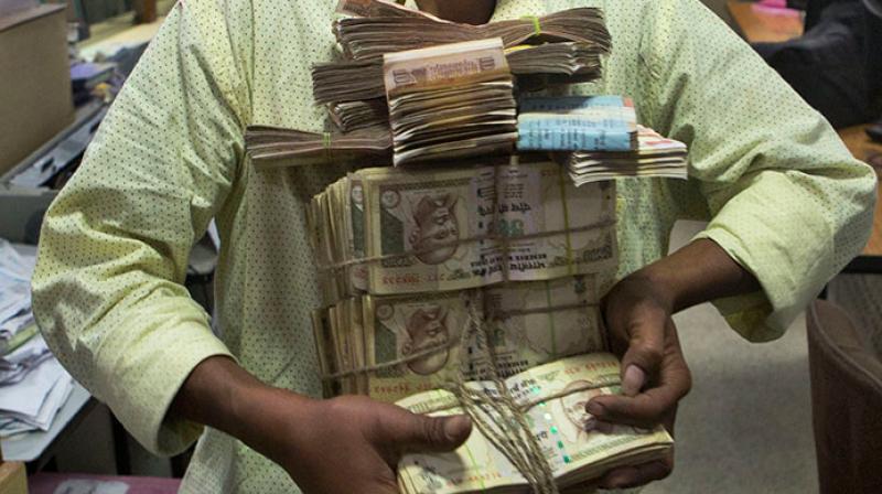 The I-T Department has slapped notices on 1.16 lakh individuals and firms who made cash deposits of more than Rs 25 lakh in bank accounts post note ban but failed to file returns by the due date. (Photo: AP/Representational) The I-T Department has slapped notices on 1.16 lakh individuals and firms who made cash deposits of more than Rs 25 lakh in bank accounts post note ban but failed to file returns by the due date. (Photo: AP/Representational)