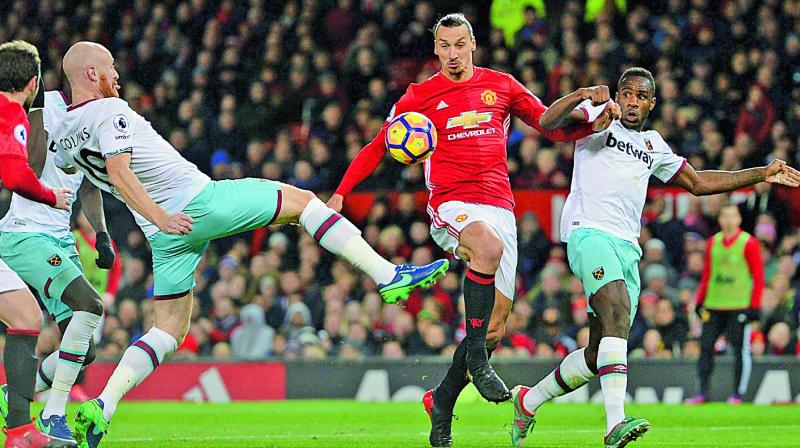 Manchester United striker Zlatan Ibrahimovic (second from right) vies for the ball with West Ham United players in their English Premier League match at Old Trafford on Sunday (Photo: AFP) Manchester United striker Zlatan Ibrahimovic (second from right) vies for the ball with West Ham United players in their English Premier League match at Old Trafford on Sunday (Photo: AFP)